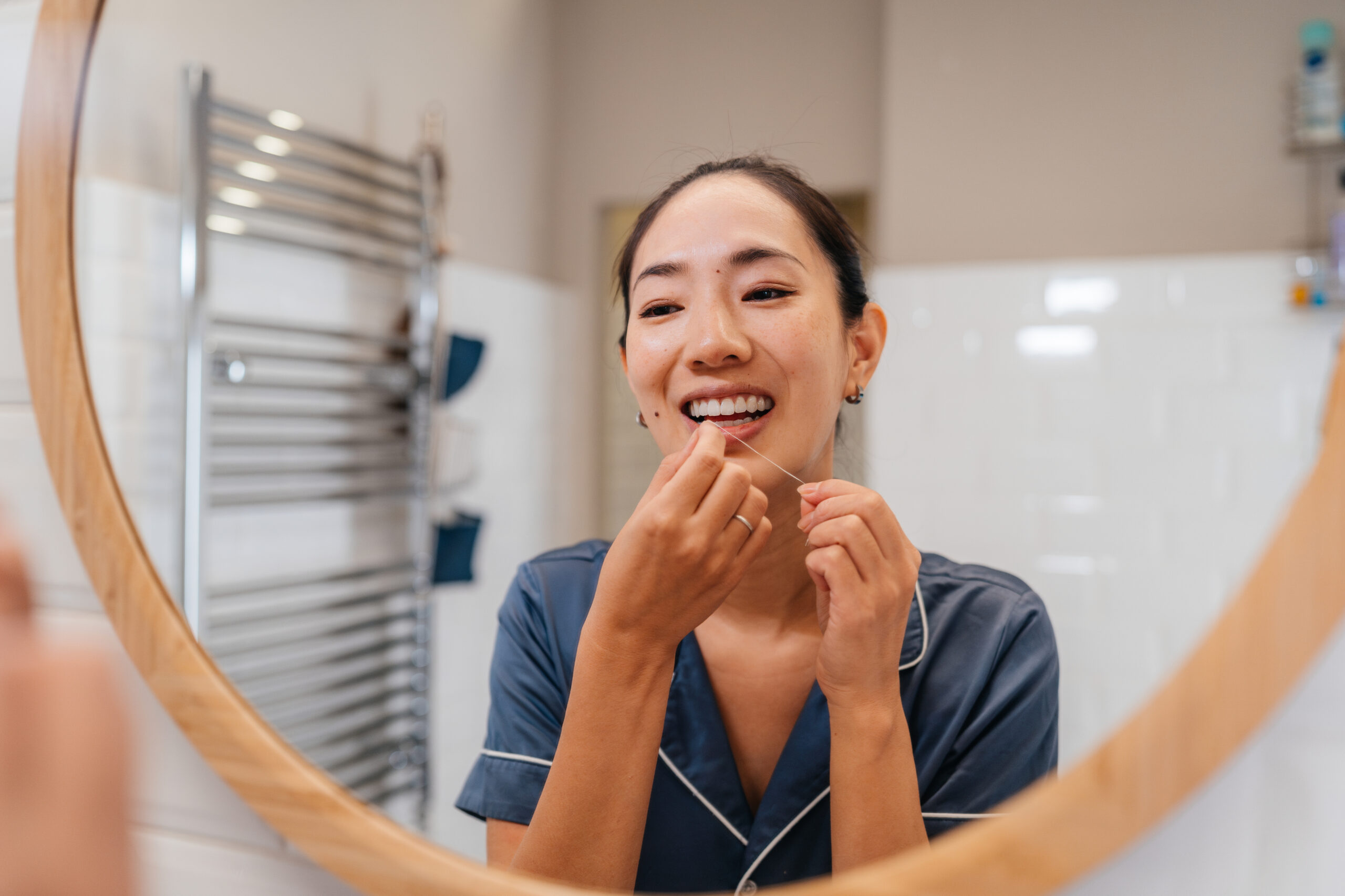 Hudsonville dentist recommending daily flossing for better gum health